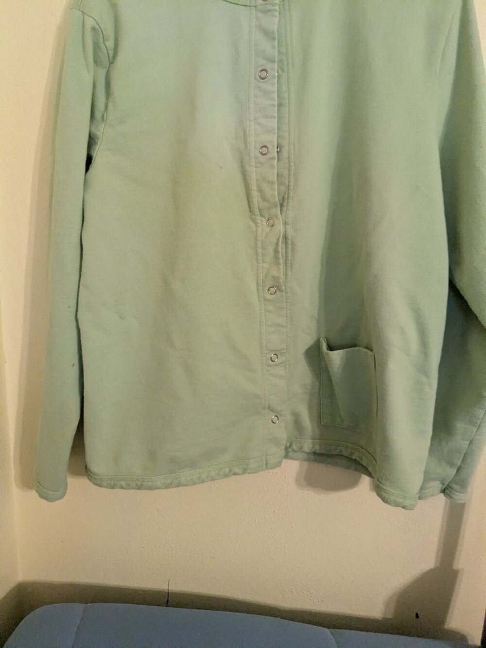 Light green top/jacket.